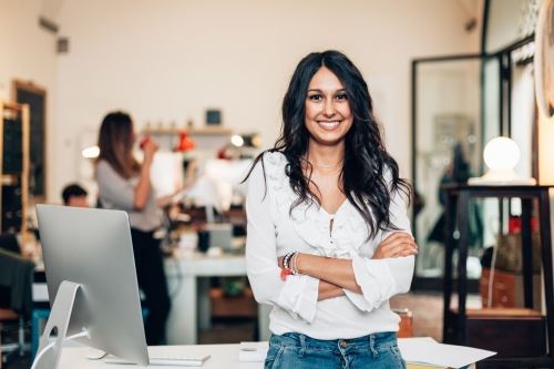 Woman cross-armed in Office